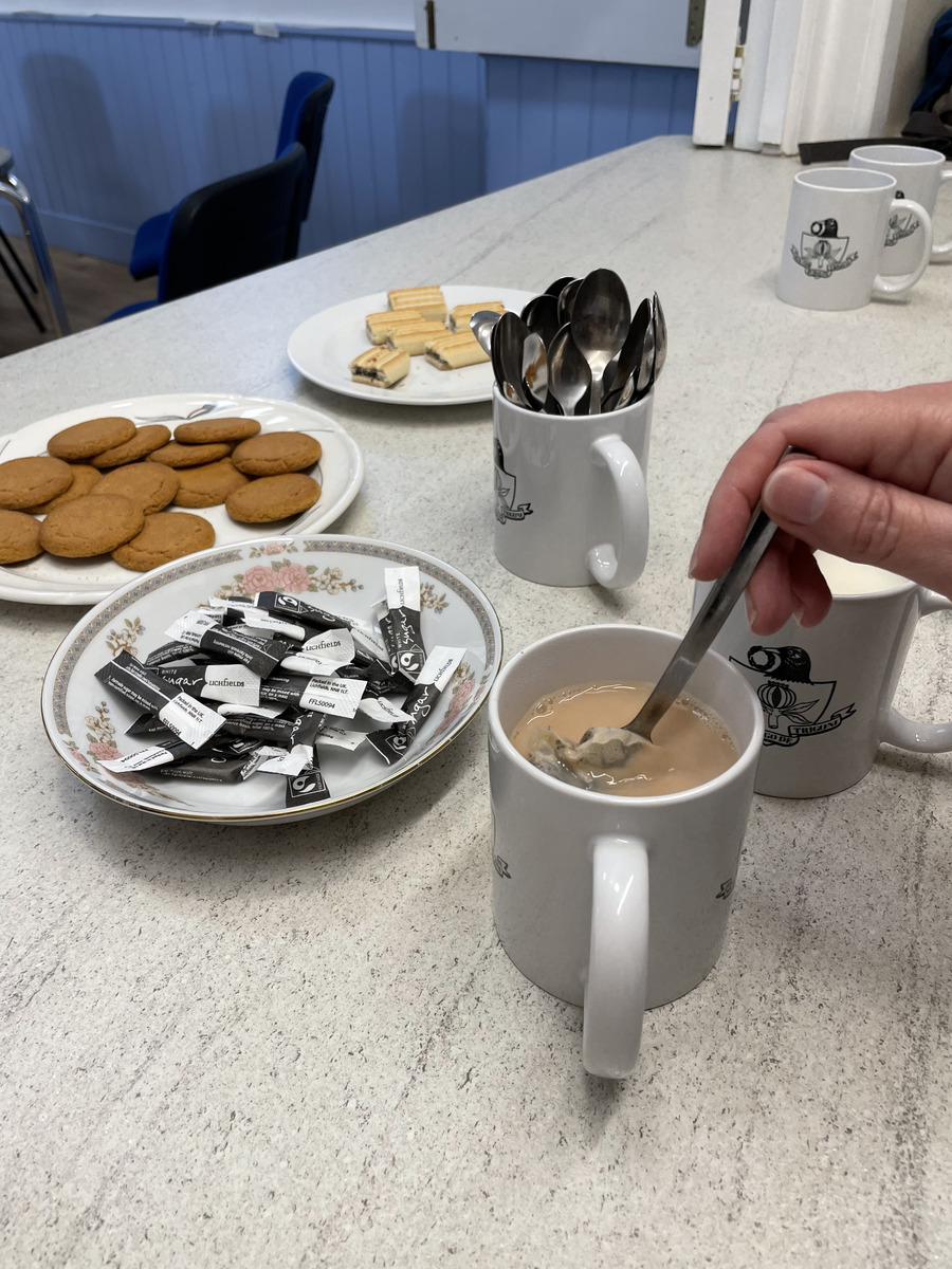 Tea, coffee, biscuits and mugs on a table for Repair Café visitors and volunteers