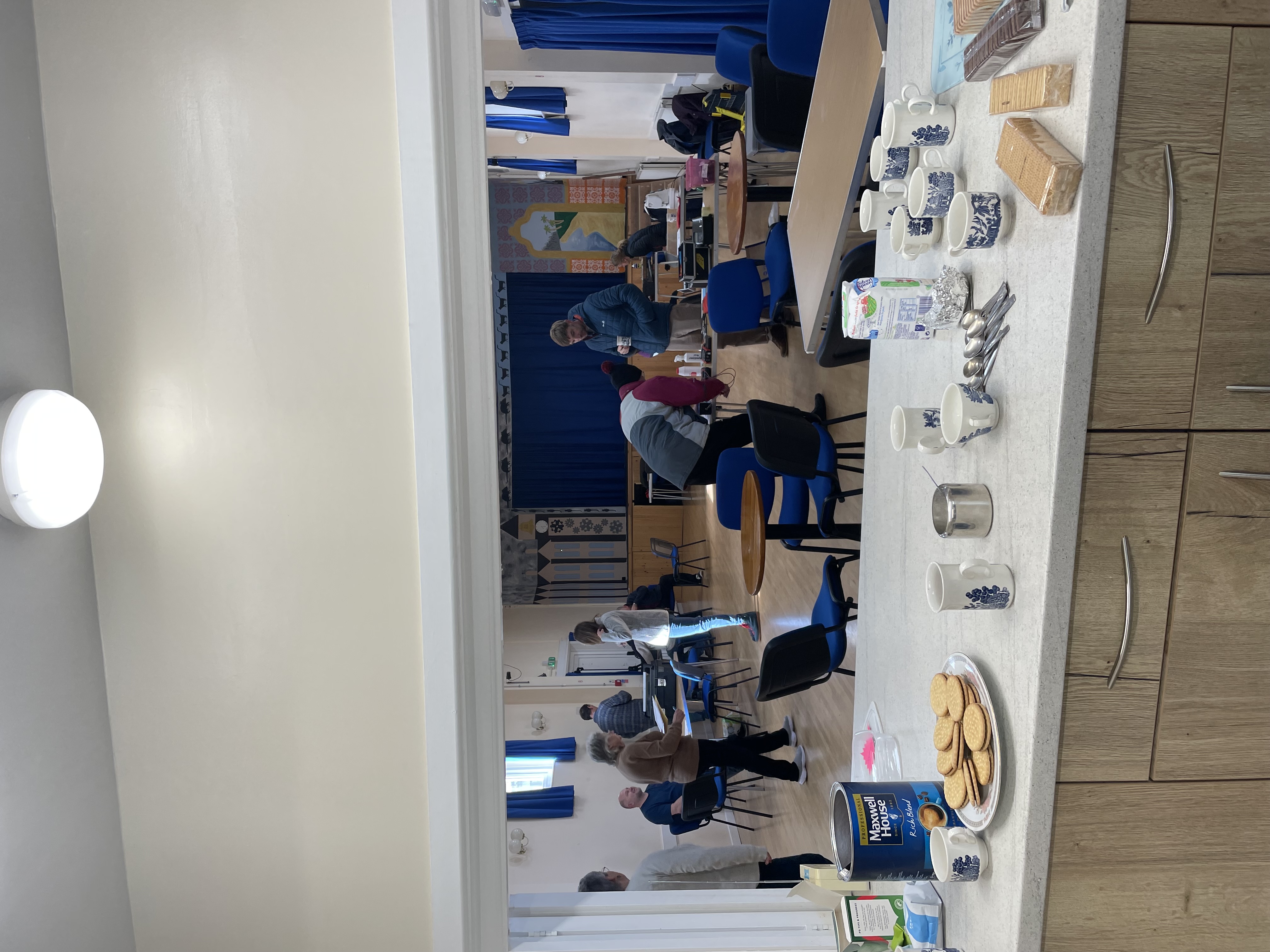 The hall bustling with volunteers and community members engaged in repairs