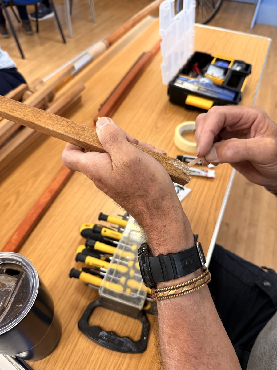 A parasol being repaired and glued at Tregony Repair Café