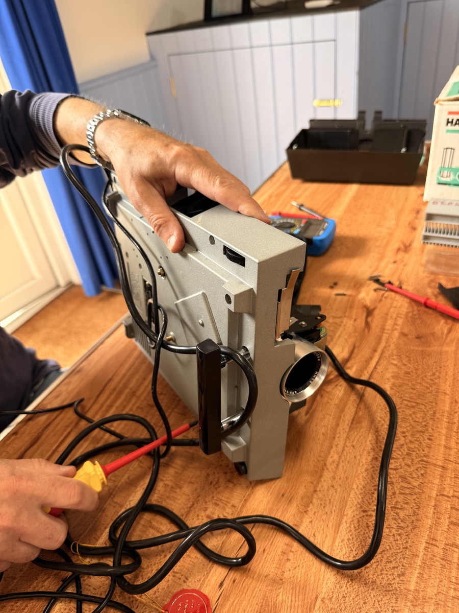 A slide projector being inspected at Tregony Repair Café