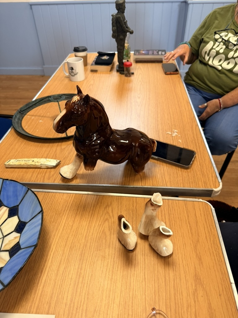 A ceramic horse ornament on a repair table
