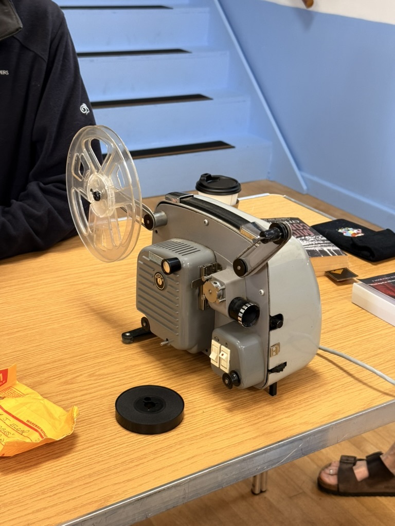 A Super 8 film projector on a repair table